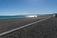 an empty beach is shown in the day time and sunny weather with bright sun shining