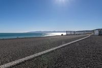 an empty beach is shown in the day time and sunny weather with bright sun shining