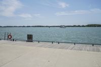 the view of water and sea with a boat going down one side of the bridge