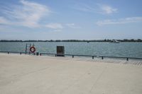 the view of water and sea with a boat going down one side of the bridge