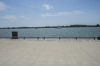 the view of water and sea with a boat going down one side of the bridge