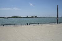the view of water and sea with a boat going down one side of the bridge