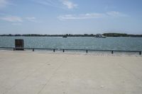 the view of water and sea with a boat going down one side of the bridge