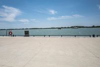 the view of water and sea with a boat going down one side of the bridge