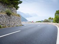 the asphalt road is paved with thin strips of white paint and has no cars driving on it