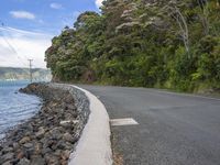 a scenic and scenic road that is next to the ocean and water with rocks on both sides