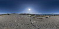 a fish eye lens that is reflecting the sun on the ground and some buildings in the background