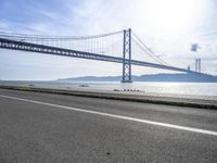 Coastal Road in Lisbon, Portugal: Crossing the Bridge Overlooking the Ocean