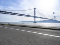 Coastal Road in Lisbon, Portugal: Crossing the Bridge Overlooking the Ocean