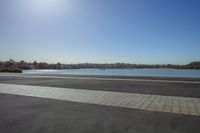 the view from across the road, looking towards a city on the water's edge