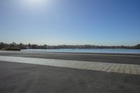 the view from across the road, looking towards a city on the water's edge