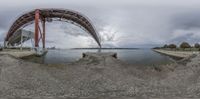 a 360 - view photo of a pier, including a man and a dog near the water