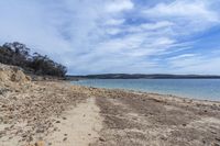 the shoreline with a sandy shore and clear water is seen here for a walk down to a beach