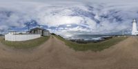 a fish eye view of a lighthouse and the ocean in the distance while on the left side