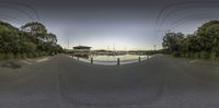 there is a fish eye view of a lake and pier at dusk in this town