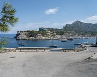 a paved road beside some large boats and a bridge with a bridge to the water