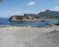 a paved road beside some large boats and a bridge with a bridge to the water