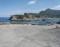 a paved road beside some large boats and a bridge with a bridge to the water