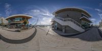 360 - image of an outdoor area that has steps and steps to different buildings, the sun in the background