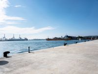 a view of a waterfront with buildings in the background and a bench near to them