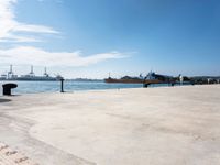 a view of a waterfront with buildings in the background and a bench near to them