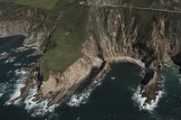 Coastal View: Ocean Cliffs and Contrails