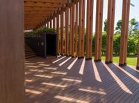 a walkway between the rooms is made from wood and has been designed in a way that allows sunlight to reach