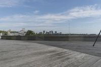 a tripod stands near a building roof with view of the city below it and people outside