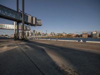 view from bridge looking over the water towards city skylines, and waterfront area with blue skies