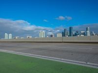 a freeway highway with city skyline in the background on a sunny day, near the beach