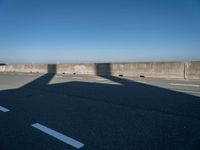 the shadow of an airplane is cast on the road by the ocean as it passes over the bridge