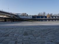 this is the walkway with two stone benches in front of it and a large building with tall chimneys and roofs