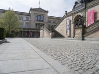 the steps on the ground have statues around them and other sculptures on the building's walls