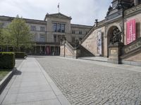 the steps on the ground have statues around them and other sculptures on the building's walls