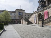 the steps on the ground have statues around them and other sculptures on the building's walls