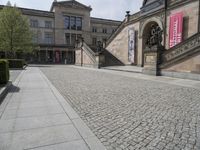 the steps on the ground have statues around them and other sculptures on the building's walls