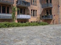 the bricks are piled up on a brick surface in a courtyard of a brick building