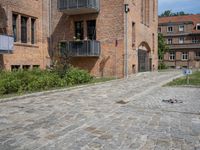 the bricks are piled up on a brick surface in a courtyard of a brick building