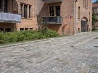 the bricks are piled up on a brick surface in a courtyard of a brick building