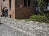 the bricks are piled up on a brick surface in a courtyard of a brick building