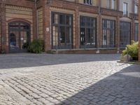 an old street with several brick buildings and a bench in front of it on the sidewalk