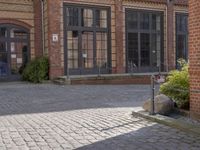 an old street with several brick buildings and a bench in front of it on the sidewalk