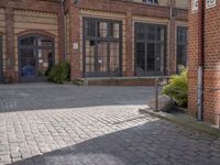 an old street with several brick buildings and a bench in front of it on the sidewalk