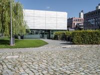 the courtyard, in which you can see the building in the background and the large trees in the foreground