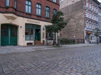 this street is a cobble stone road in europe which has the name of a small store