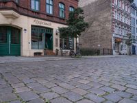 this street is a cobble stone road in europe which has the name of a small store