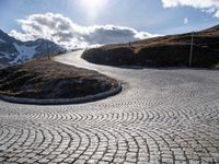 a paved road winds its way to the top of the mountain in switzerland or austria