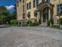 large yellow building with some plants and bushes in front of it for decoration or entertainment