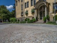 large yellow building with some plants and bushes in front of it for decoration or entertainment