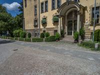 large yellow building with some plants and bushes in front of it for decoration or entertainment